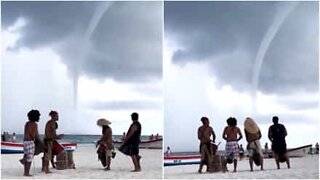 Musicians jamming on the beach while a tornado looms