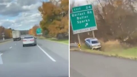 Vehicle drives off the highway, jumps ramp right underneath road sign