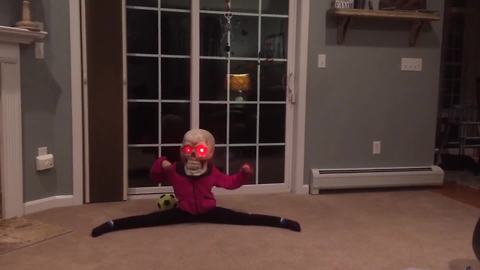 Little Girl Dances With A Halloween Skull Decoration On Her Head