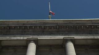 City Hall flag half-staff in honor of fallen patrol officer