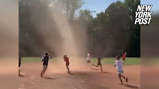 Tornado at baseball game: Kids run through dust devil