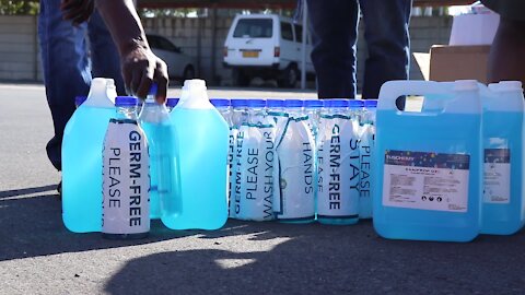 South Africa - Cape Town - Ward Councillor Sonwabile Ngxumza donating hand sanitizers (Js6)