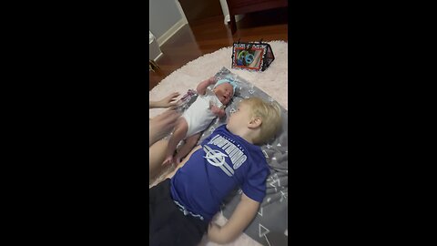 Toddler and baby sister do some tummy time.