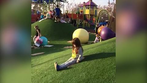 Little Girl Goes Sledding on Cardboard