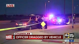 Officer dragged by suspect's vehicle, suspect still on the run