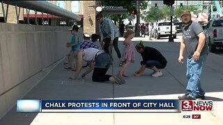 Chalk protests in front of City Hall