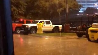 Man takes advantage of rain to wash his car