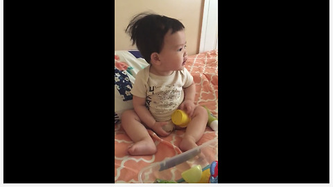 Baby dances to rhythm of ceiling fan