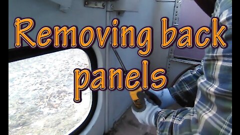 Removing back panels for bus conversion to RV.