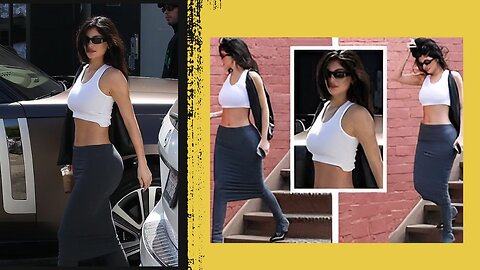Kylie Jenner bares her toned abs in a cropped tank top and skirt.