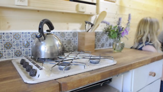 Couple pack it all in and move into their new mobile home - an old white van