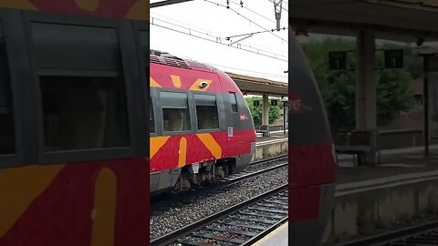 French SNCF Bombardier Autorail à grande capacité AGC set leaving Nîmes in the rain Occitanie