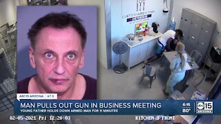 Father disarms man after gun is pulled during meeting