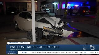 Car crashes into support beam, 2 people hurt