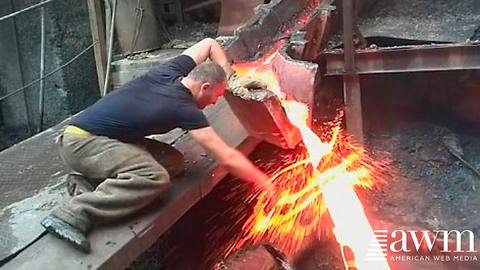 On A Bet Worker Sticks His Hand Into A Spout Of Molten Metal