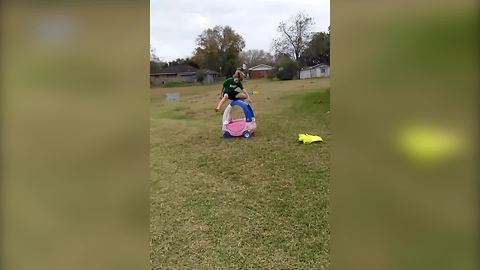 "Sibling Rivalry: Three Kids Jumping Across Toy Car"