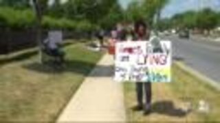 Protestors line up outside Vince's Crabhouse during owners' press conference