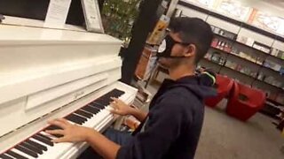 Young man plays the piano blindfolded