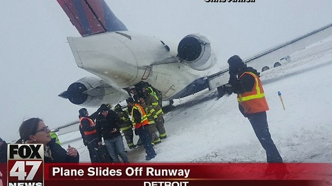 Plane slides off runway at Detroit Metro Airport during snowstorm