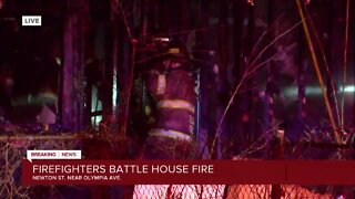 Firefighters battle house fire