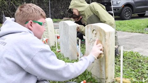 Boy scouts team up to clean veterans' headstones at Pasco County cemetery