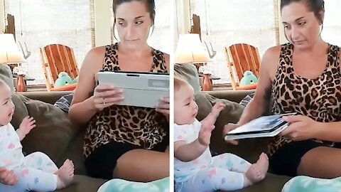 Baby crying because he sees his mother fiddling with a tablet