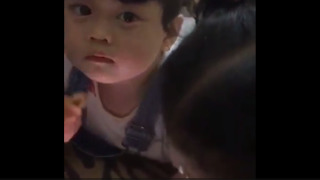 Cute little baby using tablet and eat