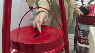 Salvation Army bell ringer sings while he rings at Tops in Hamburg