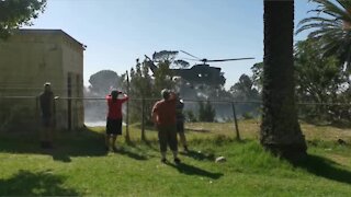 SANDF Oryx helicopter collecting water to fight Table Mountain fire