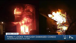 Family looks through damaged condo