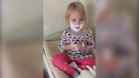 A Tot Girl Rubs Some Cream On Her Face Just Like Her Dad When He Shaves