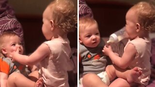 Toddler Hilariously Attempts To Bottle Feed Baby Brother
