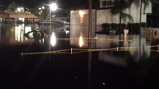 Cars under water in Fort Myers parking lot