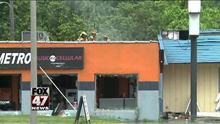 Crews battling fire at local party store