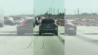 Cellphone video shows driver waving gun through sunroof on I-95