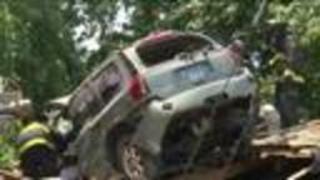 SUV crashes into roof of home