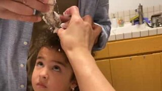 Little girl's hair gets tangled in food mixer while making cakes