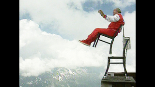 Guy Balances Chair Over Precipice