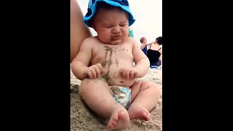 Funny baby reaction on the beach