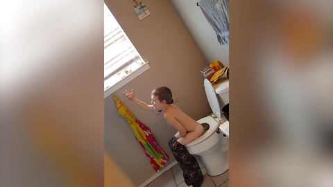 Young Boy Is Singing On The Toilet