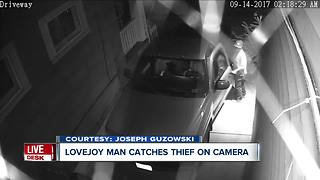 Surveillance video catches man breaking into car