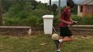 Youngster casually flicks football in garbage bin with amazing trick shot