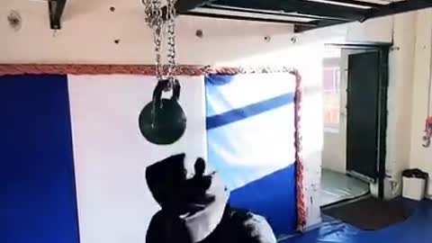 Blindfolded Guy Practices Boxing Around Swinging Kettlebell