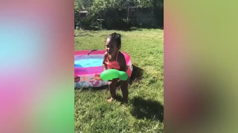 Funny baby playing water|