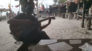 Guy Sings Bob Marley On Beach