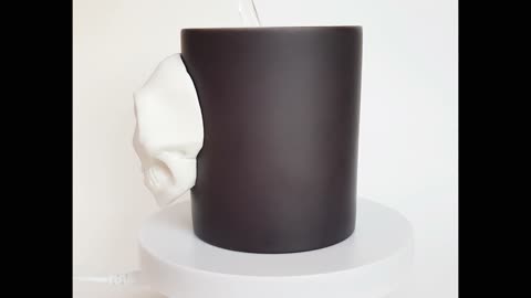 Black chameleon mug with a human skull made of polymer clay. Handmade cup with skull by AnneAlArt