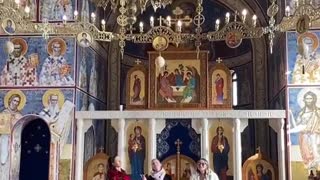 Trio of women sing inside an Orthodox Church