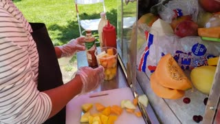 Street food. Mexican style fruit salad with lemon and some Mexican salt.