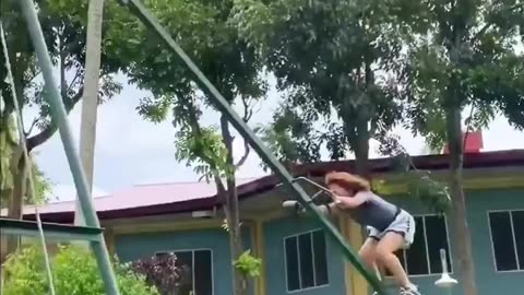 A woman rotates 360 degrees on a SWING.