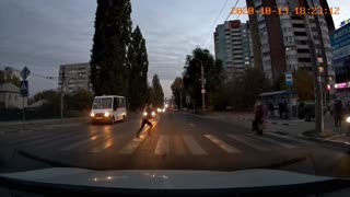 Car Swerves Around Pedestrian at the Last Moment